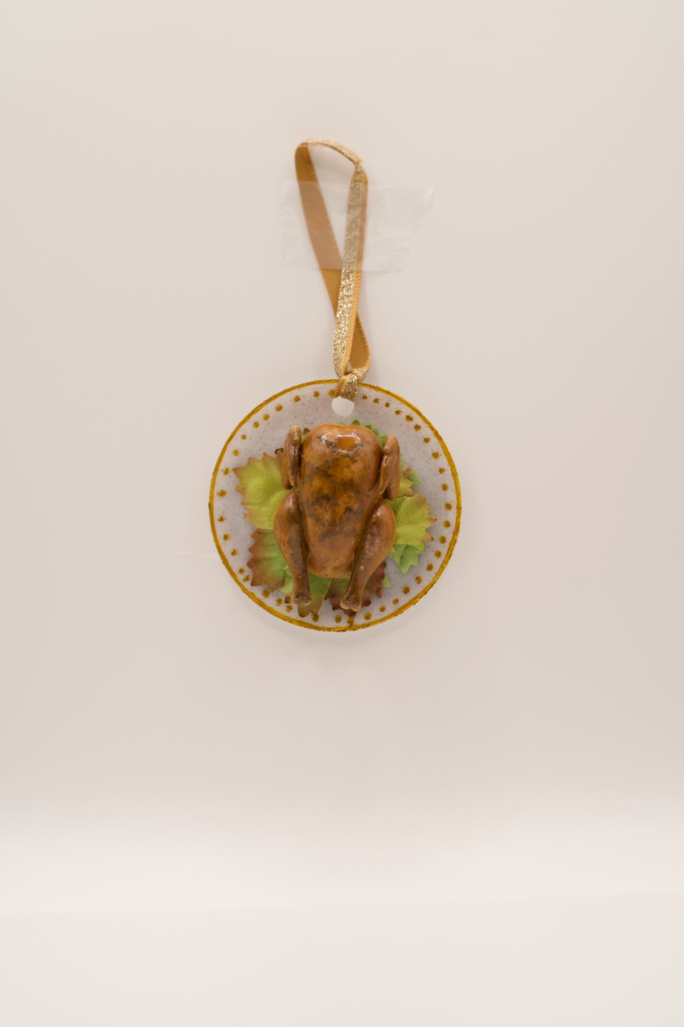 Miniature roast chicken and garnish ornament on a decorative plate